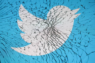 Illustration shows Twitter app logo through broken glass