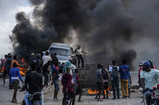 A motorcade tries to get through a roadblock a day before the funeral of Jovenel Moise in Cap-Haitien, Haiti, July 22, 2021. (Federico Rios Escobar/The New York Times)