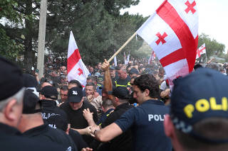 Anti-LGBTQ protesters scuffle with police as they try to break into the site of Tbilisi Pride Fest