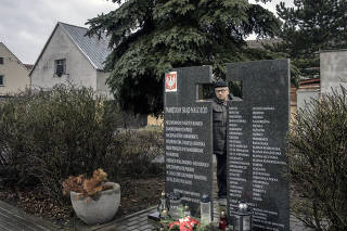 Ryszard Marcinkowski, a son of a survivor of the massacre in Volhynia, and leader of the Borderlands Association, at a monument commemorating lives lost in 1943 in Swiatniki, Poland, Feb. 18, 2023. (Maciek Nabrdalik/The New York Times)