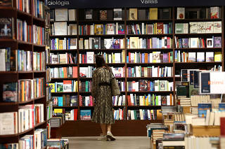 A customer looks at books at Hungary's second largest bookstore Lira in Budapest