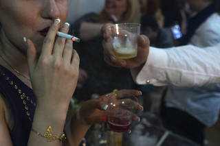 Illicit alcohol is served at a party in Tehran, Iran.  (The New York Times)