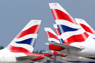 FILE PHOTO: British Airways tail fins are pictured at Heathrow Airport in London