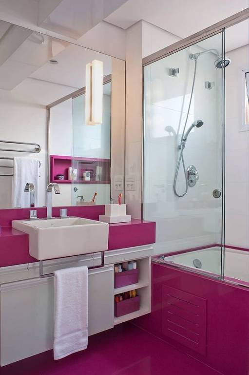 Banheiro com bancada, piso e banheira rosa-choque