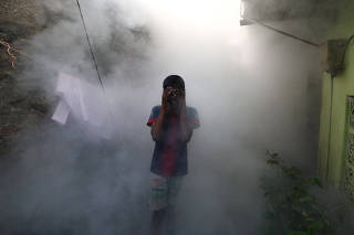 FILE PHOTO: A health worker fumigates against mosquitoes in a residential area, as Sri Lanka tries to curb dengue fever across the island in Colombo