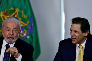 FILE PHOTO: Brazil's President Luiz Inacio Lula da Silva speaks alongside Brazil's Finance Minister Fernando Haddad