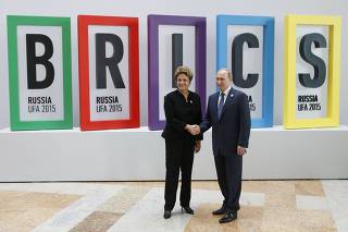 Russian President Putin shakes hands with Brazil's President Rousseff during the welcoming ceremony at the BRICS Summit in Ufa