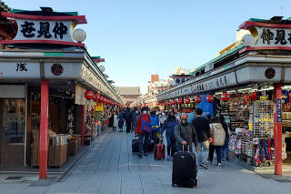 FILE PHOTO: Japan visitors surge past 2 mln in June for first time since COVID