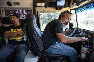 Manuel Oliver, a Parkland parent, drives a converted school bus before a rally in Uvalde, Texas, July 11, 2023. (Victor J. Blue/The New York Times)
