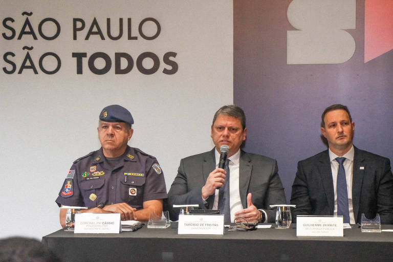 Tarcísio de Freitas (ao centro), ao lado do comandante-geral da PM, Cássio Araújo de Freitas, e do secretário da Segurança, Guilherme Derrite, durante entrevista à imprensa sobre a operação da PM em Guarujá 