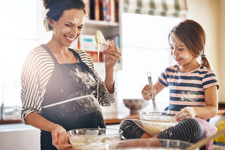 Mother, playful or kid baking in kitchen as a happy family with an excited girl laughing or learning cookies recipe. Smile, flour or funny mom helping or teaching kid to bake for development at home