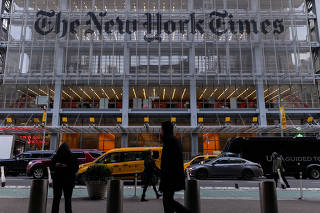FILE PHOTO: Pedestrians walk by the New York Times building in Manhattan