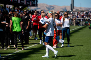 Julie Ertz, on the U.S. WomenÕs National Team, holds her son Madden after a World Cup preparatory match against Wales in San Jose, Calif., July 9, 2023. (Marlena Sloss/The New York Times)