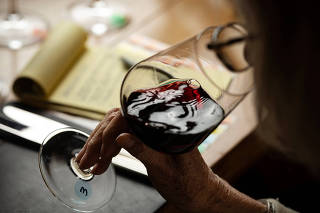 A woman drinks wine in New York, Oct. 26, 2022. (Karsten Moran/The New York Times)