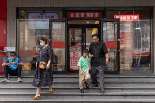 People leave a Nanchengxiang restaurant in Beijing