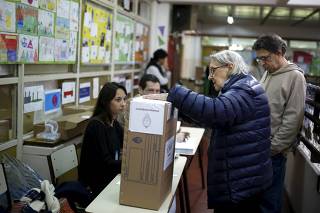 A citizen casts her ballot during Argentina's presidential election in Buenos Aires