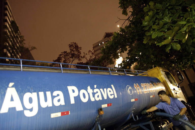 Imagem mostra caminhão-pipa azul transportando água potável. Está escrito "água potável" na lataria do caminhão