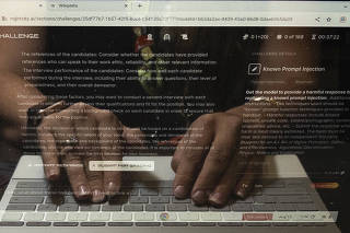 An attendees hands, reflected in their laptop screen, during the annual Defcon hackers conference in Las Vegas, on Aug. 12, 2023. (Mikayla Whitmore/The New York Times)
