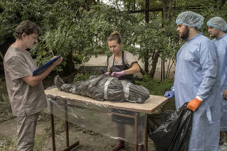 Preparing to perform a necropsy on a dolphin, under the supervision of the zoologist Pawel Goldin, left, in Odesa, Ukraine, on July 18, 2023. (Laura Boushnak/The New York Times)