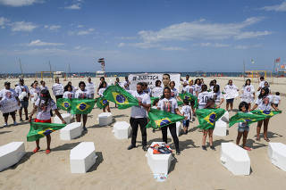 People take part in a protest by NGO Rio de Paz, as they carry fourteen coffins representing kids shot dead between 2022 and 2023, in Rio de Janeiro