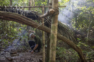 Jair Candor, an agent from BrazilÕs Indigenous agency, inspects a shelter that he believes was used by Pakyi and Tamandua, in the Piripkura territory, in Mato Grosso, Brazil on July 26, 2023. (Victor Moriyama/The New York Times)