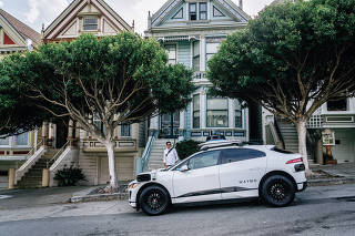 A Waymo driverless Jaguar in front of the Alamo Square houses known as the Painted Ladies, in San Francisco, Aug. 21, 2023. (Andri Tambunan/The New York Times)