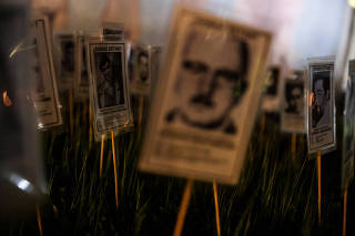 Relatives and activists pay tribute to the victims of Pinochet dictatorship, in Santiago