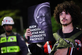 Demonstrators attend a march against police violence towards the Black community and for Mae Bernadete Pacifico, in Sao Paulo
