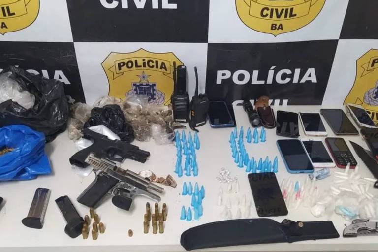 Armas, facas, drogas e outros materiais encontrados com os suspeitos sob uma mesa na delegacia