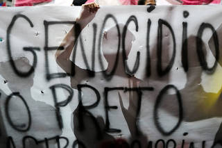 Demonstrators attend a march against police violence towards the Black community, in Rio de Janeiro