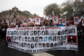 Demonstrators take part in a march marking the 49th anniversary of the 1973 Chile military coup, in Santiago