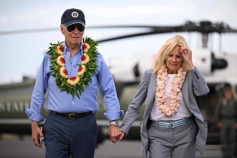 O presidente dos EUA, Joe Biden, e a primeira-dama Jill Biden com colares havaianos antes de embarcarem no aeroporto de Kahului, no Havaí, após visita a socorristas e sobreviventes dos incêndios em Maui