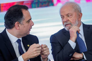 Brazil's Senate President Rodrigo Pacheco talks with Brazil's President Luiz Inacio Lula da Silva during a ceremony at the Planalto Palace in Brasilia