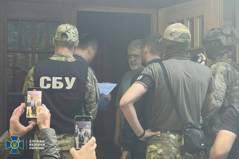 Agentes de segurança falam com o bilionário Ihor Kolomoiski, em imagem divulgada neste sábado (2), sem informações sobre o local