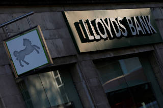 FILE PHOTO: Signs are seen outside a branch of Lloyds Bank in central London