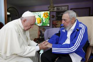 Pope Francis and former Cuban President Fidel Castro hold hands in Havana
