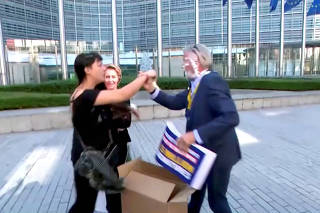 Ryanair CEO Michael O'Leary gets hit in the face by cream cakes during a press briefing outside the EU Commission, in Brussels