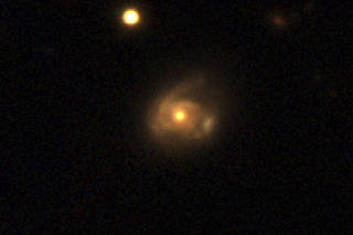 Interaction between a supermassive black hole in a galaxy named 2MASX J02301709+2836050 and a star orbiting it