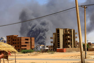 FILE PHOTO: Smoke rises above buildings after an aerial bombardment in Khartoum North