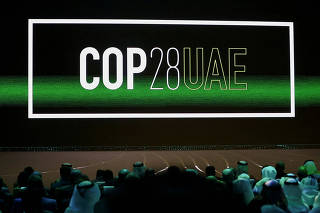 FILE PHOTO: 'Cop28 UAE' logo is displayed on the screen during the opening ceremony of Abu Dhabi Sustainability Week (ADSW) under the theme of 'United on Climate Action Toward COP28', in Abu Dhabi