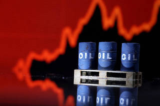 FILE PHOTO: Illustration shows Oil barrels in front of rising stock graph