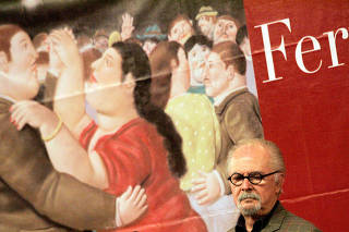 FILE PHOTO: Colombian painter and sculptor Fernando Botero listens during a news conference for the 
