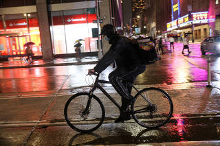 FILE PHOTO: Food delivery riders in Midtown Manhattan
