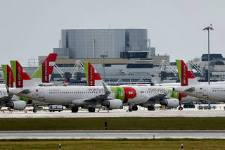 FILE PHOTO: TAP planes are seen at Lisbon's airport  during partial lockdown as part of state of emergency to combat the coronavirus disease (COVID-19) outbreak in Lisbon