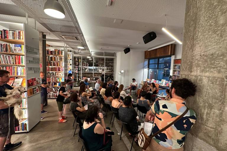 Imagem ampliada da livraria Megafauna que mostra pessoas assistindo à conversa entre as autoras do Morte sem Tabu e a escritora Mariana Carrara