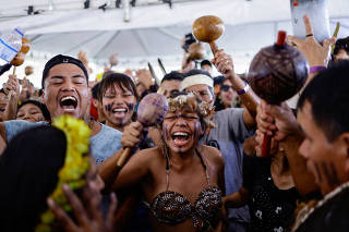 Brazilian Xokleng Indigenous people celebrate after a majority on Brazil's Supreme Court voted against the so-called legal thesis of 'Marco Temporal', in Brasilia