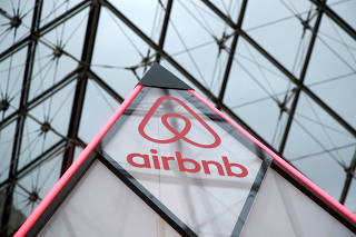 FILE PHOTO: FILE PHOTO: Airbnb logo is seen on a little mini pyramid under the glass Pyramid of the Louvre museum in Paris