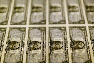 FILE PHOTO: U.S. dollar bills are seen on a light table at the Bureau of Engraving and Printing in Washington