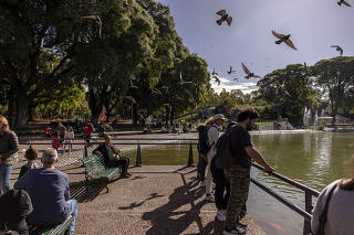 Visitors look out over the lake at Parque Centenario in Buenos Aires on May 7, 2023.  (Sarah Pabst/The New York Times)