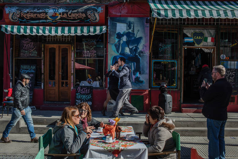 1º Buenos Aires | Na foto, dupla dança tango em frente a restaurante na região turística de Caminito, conhecida por casas e paredes coloridas